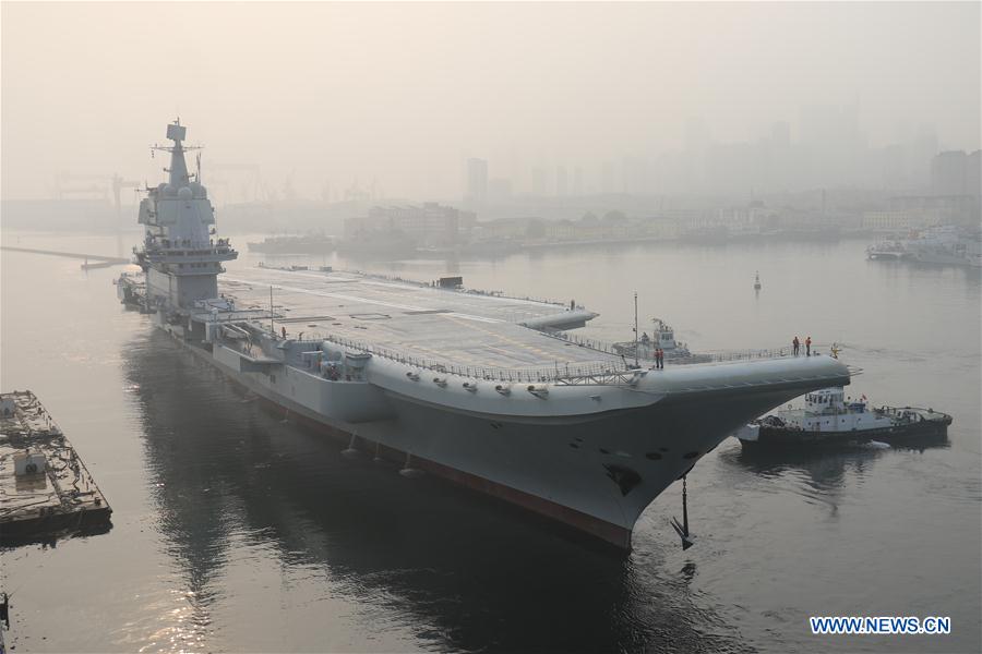China's second aircraft carrier and first indigenously built one being towed from its fitting out berth in Dalian, northeastern China, 2018.
